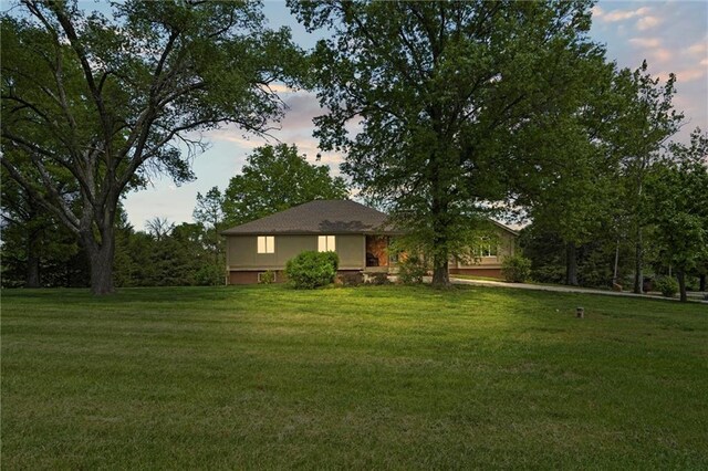 19864 211th St, Tonganoxie, KS 66086 - yard at dusk featuring a lawn