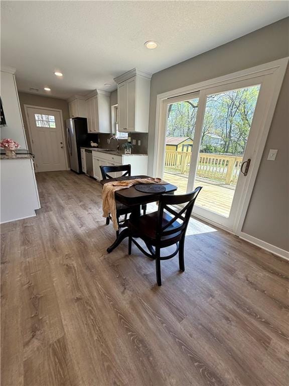 112 Benton St, Pleasant Hill, MO 64080 - dining space with a textured ceiling, wood finished floors, baseboards, and recessed lighting