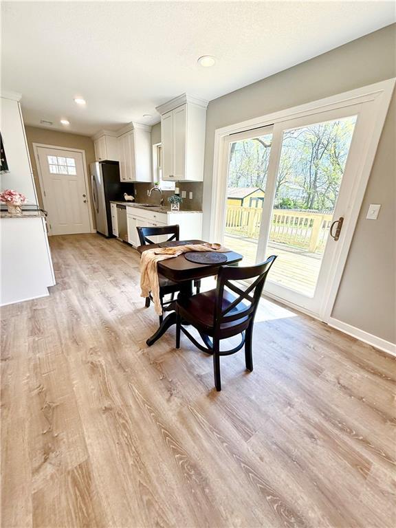 112 Benton St, Pleasant Hill, MO 64080 - dining room with light wood-type flooring, baseboards, and recessed lighting