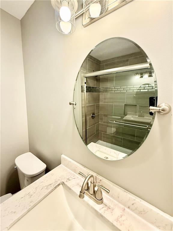 112 Benton St, Pleasant Hill, MO 64080 - bathroom with toilet, tiled shower, and vanity