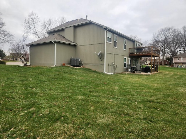 5773 Meadow Heights Dr, Shawnee, KS 66226 - rear view of property with a wooden deck, central AC, and a lawn