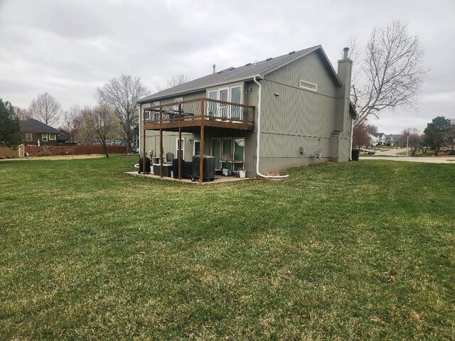 5773 Meadow Heights Dr, Shawnee, KS 66226 - rear view of house with a deck, a chimney, a lawn, and central AC unit
