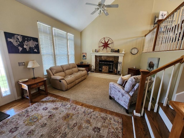 5773 Meadow Heights Dr, Shawnee, KS 66226 - living area featuring wood finished floors, stairs, a ceiling fan, a fireplace, and high vaulted ceiling