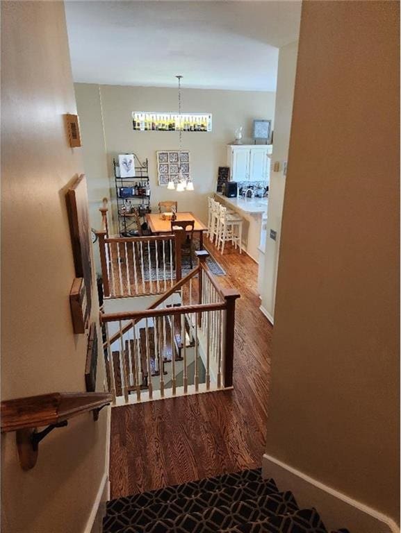 5773 Meadow Heights Dr, Shawnee, KS 66226 - stairway featuring a chandelier and baseboards