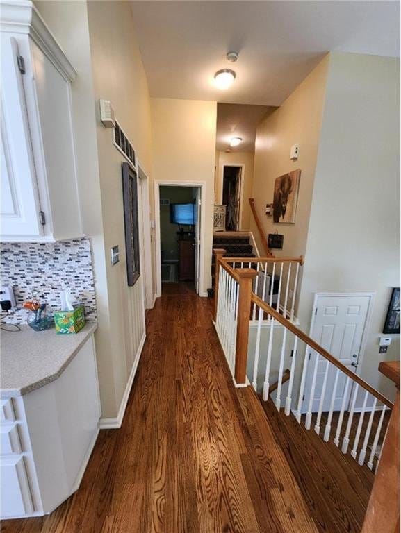 5773 Meadow Heights Dr, Shawnee, KS 66226 - hallway with dark wood-style flooring, an upstairs landing, and baseboards