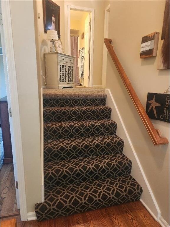5773 Meadow Heights Dr, Shawnee, KS 66226 - staircase with wood finished floors and baseboards