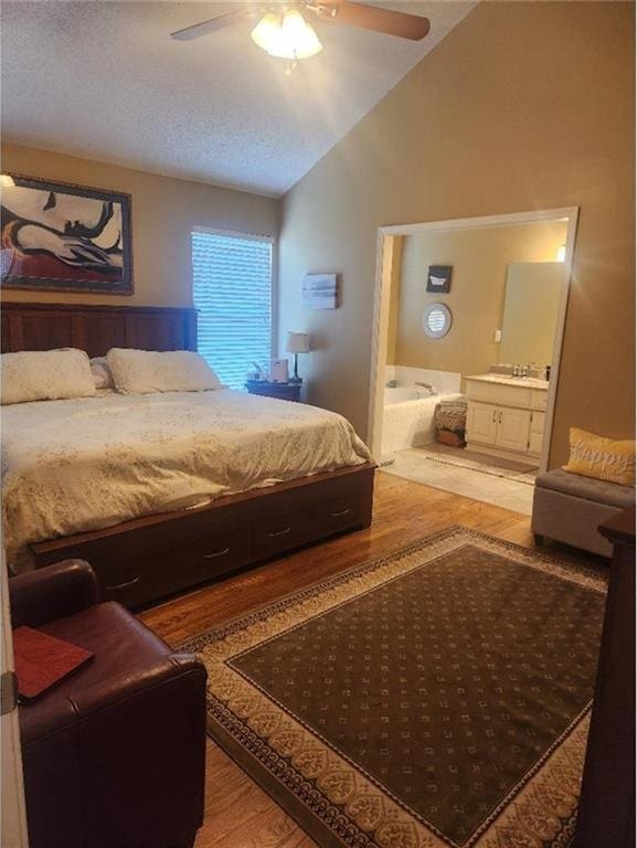 5773 Meadow Heights Dr, Shawnee, KS 66226 - bedroom featuring wood finished floors, lofted ceiling, ensuite bath, ceiling fan, and a textured ceiling