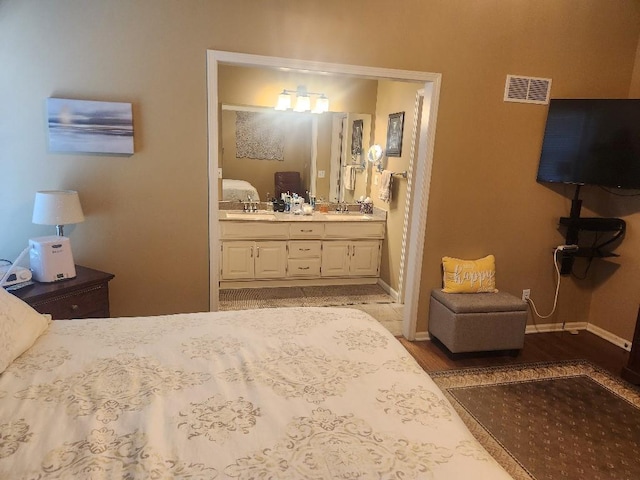 5773 Meadow Heights Dr, Shawnee, KS 66226 - bedroom with a sink, wood finished floors, baseboards, and ensuite bathroom