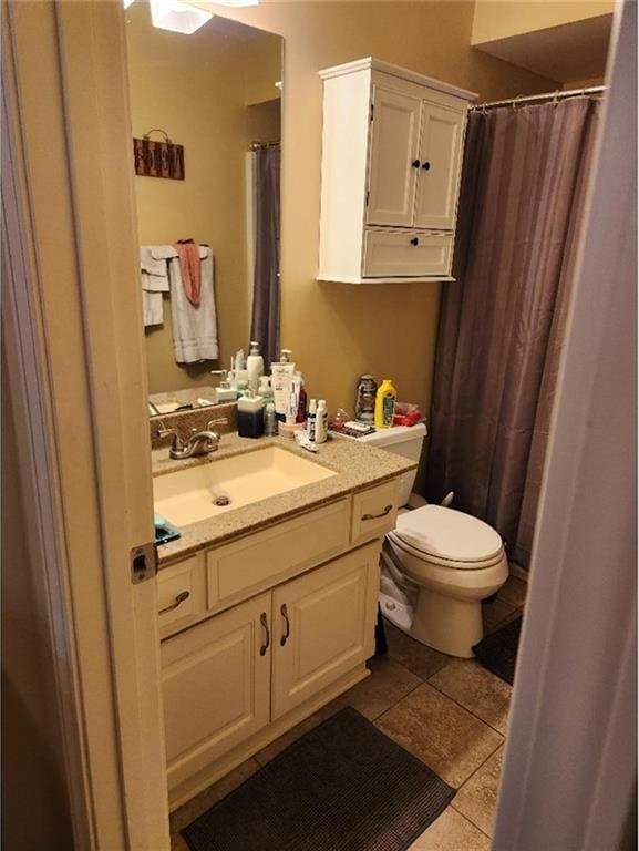 5773 Meadow Heights Dr, Shawnee, KS 66226 - bathroom featuring toilet, vanity, tile patterned floors, and a shower with shower curtain