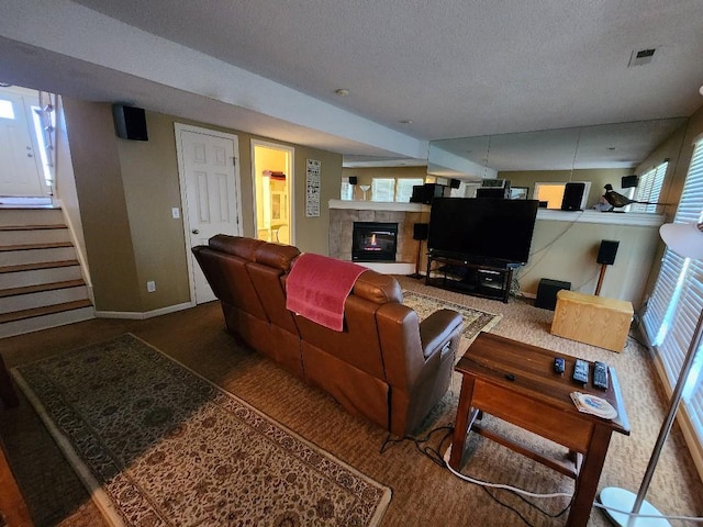 5773 Meadow Heights Dr, Shawnee, KS 66226 - carpeted living room featuring a tiled fireplace, a textured ceiling, baseboards, and stairway