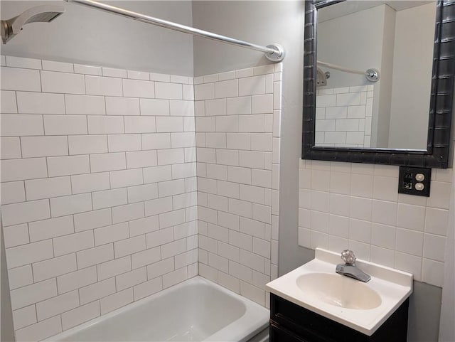 bathroom featuring vanity, shower / bathing tub combination, and tile walls