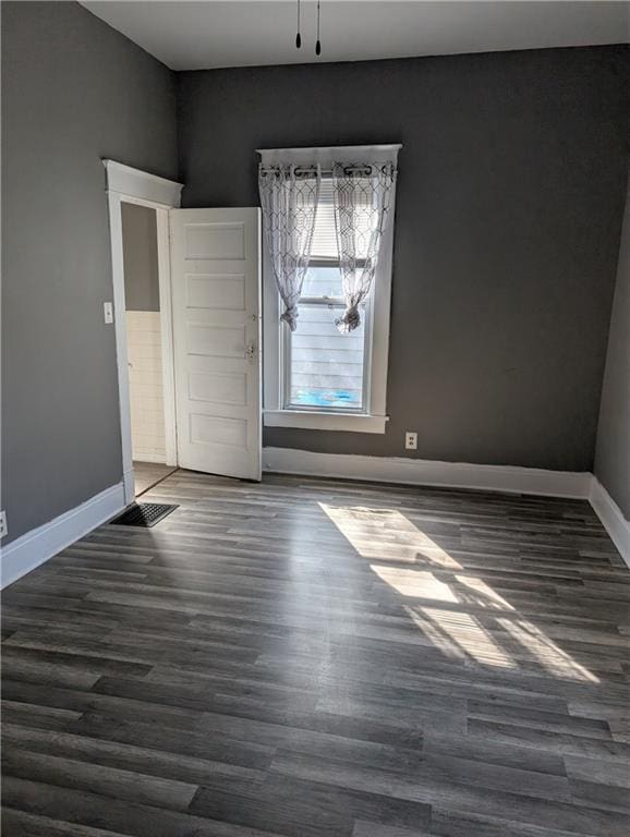 interior space featuring baseboards, dark wood finished floors, and visible vents