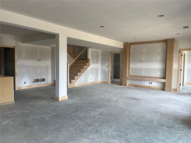 16929 Parkhill St, Overland Park, KS 66221 - unfurnished living room featuring stairs and unfinished concrete flooring