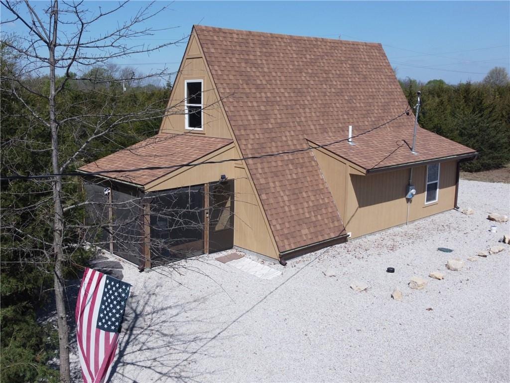 exterior space with a shingled roof