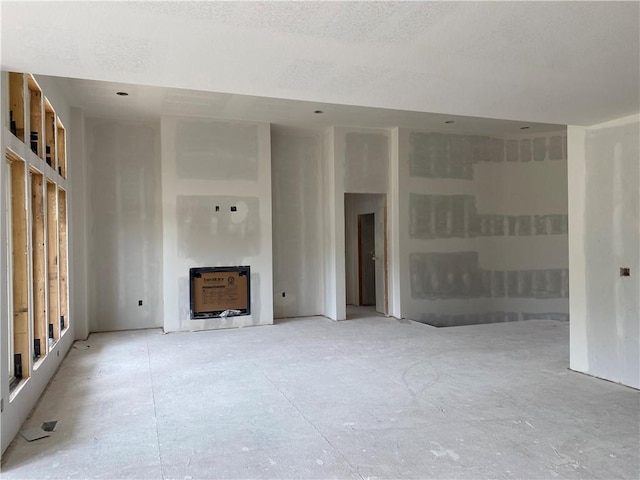 3010 NE 102nd St, Kansas City, MO 64155 - unfurnished living room with a fireplace and a textured ceiling