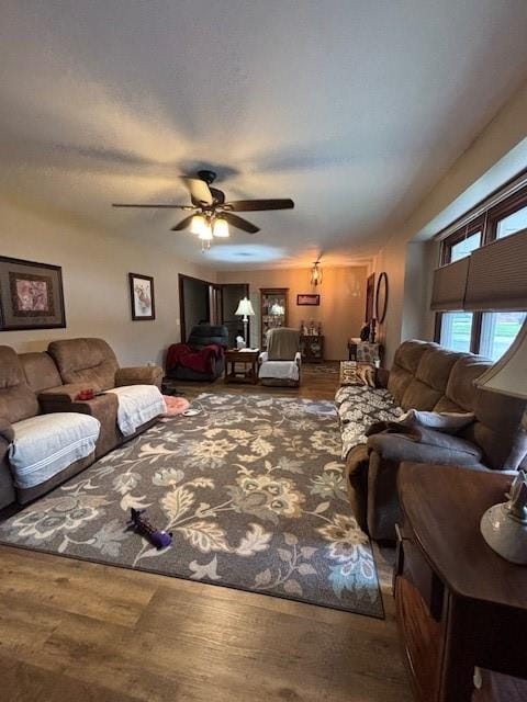 living room featuring wood finished floors and a ceiling fan