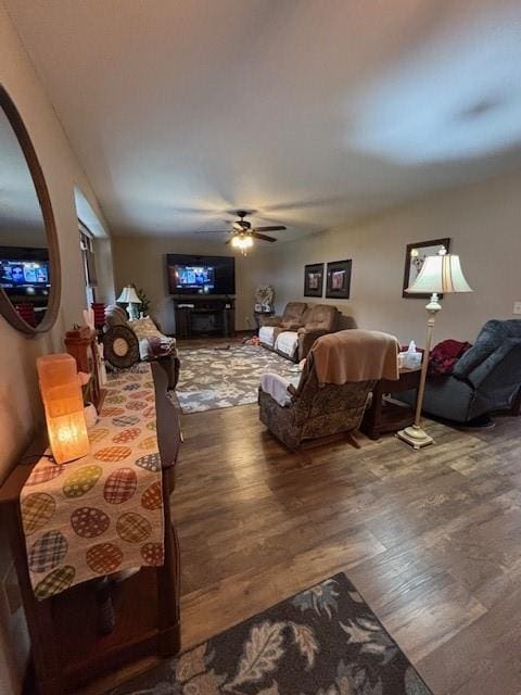 living area with ceiling fan and wood finished floors