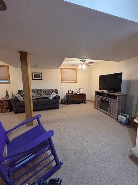 carpeted living room featuring a ceiling fan
