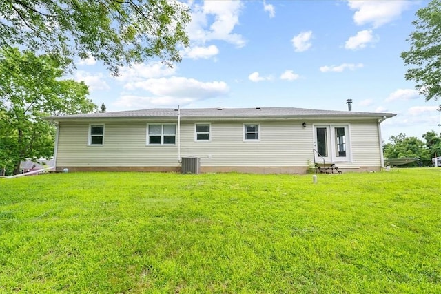 back of property featuring a yard, entry steps, and central AC