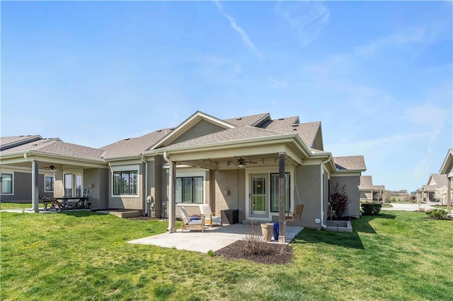 11481 S Waterford Dr, Olathe, KS 66061 - rear view of house with a patio, a ceiling fan, stucco siding, and a yard