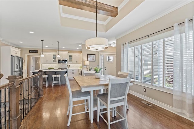 11481 S Waterford Dr, Olathe, KS 66061 - dining space with visible vents, ornamental molding, and dark wood-type flooring