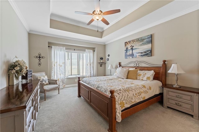 11481 S Waterford Dr, Olathe, KS 66061 - bedroom featuring ornamental molding, a ceiling fan, a tray ceiling, and light colored carpet