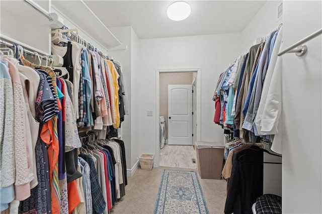 11481 S Waterford Dr, Olathe, KS 66061 - walk in closet with carpet flooring and washer and dryer