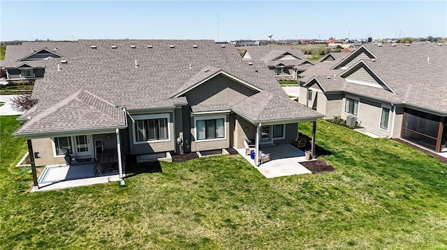 11481 S Waterford Dr, Olathe, KS 66061 - rear view of property with a yard, a shingled roof, a patio area, and stucco siding