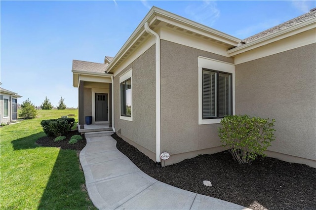 11481 S Waterford Dr, Olathe, KS 66061 - doorway to property featuring stucco siding and a yard