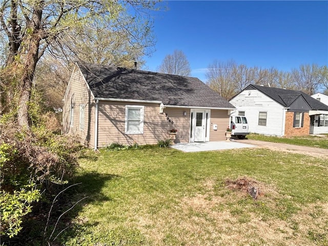 7940 Hickman Mills Dr, Kansas City, MO 64132 - view of front of property with a shingled roof, a front yard, and a patio