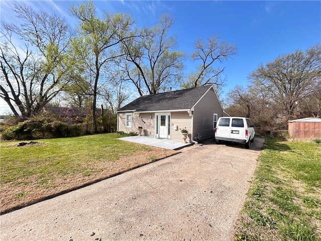 7940 Hickman Mills Dr, Kansas City, MO 64132 - exterior space featuring driveway and a front yard