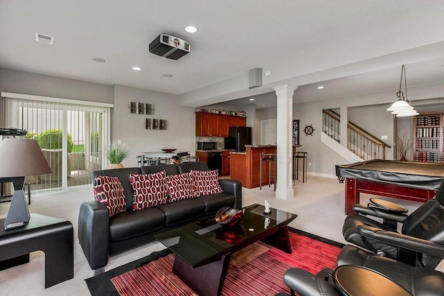 living room featuring visible vents, decorative columns, stairs, light carpet, and recessed lighting