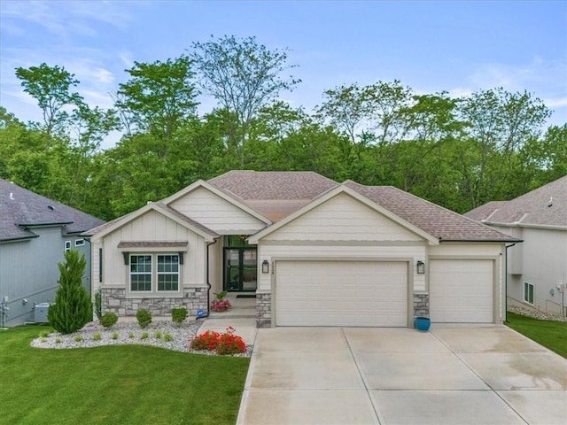 2428 W 179th St, Overland Park, KS 66085 - ranch-style home with an attached garage, concrete driveway, stone siding, and a front yard