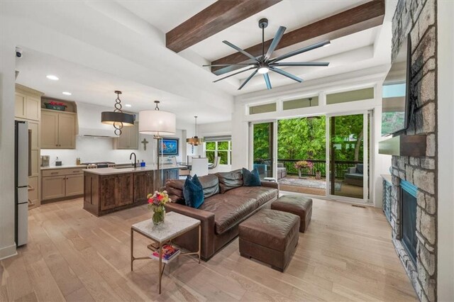 2428 W 179th St, Overland Park, KS 66085 - living area with light wood-type flooring, a ceiling fan, a fireplace, beamed ceiling, and recessed lighting