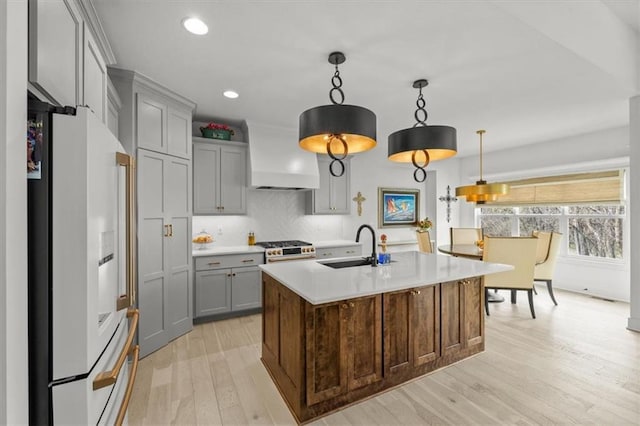 2428 W 179th St, Overland Park, KS 66085 - kitchen featuring white fridge with ice dispenser, custom range hood, gray cabinetry, a sink, and light countertops