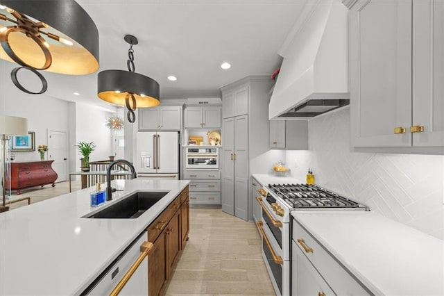 2428 W 179th St, Overland Park, KS 66085 - kitchen with premium appliances, a sink, premium range hood, light countertops, and recessed lighting