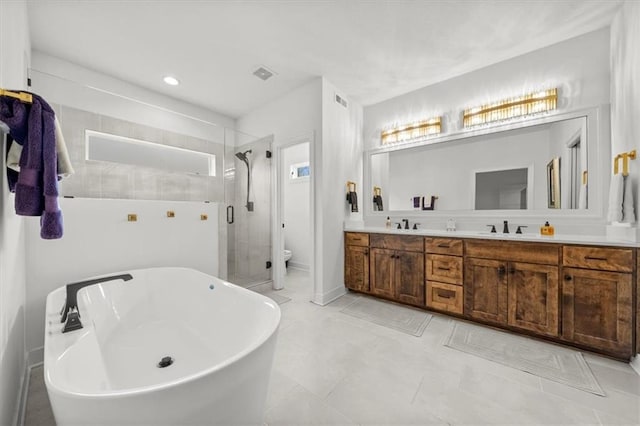 2428 W 179th St, Overland Park, KS 66085 - full bath with double vanity, a shower stall, toilet, a soaking tub, and tile patterned floors
