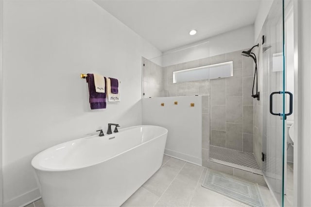 2428 W 179th St, Overland Park, KS 66085 - bathroom featuring a stall shower, a freestanding bath, toilet, baseboards, and tile patterned flooring