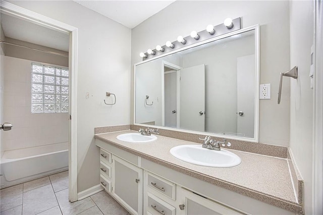 full bathroom featuring double vanity, a sink, tile patterned floors, and bathtub / shower combination