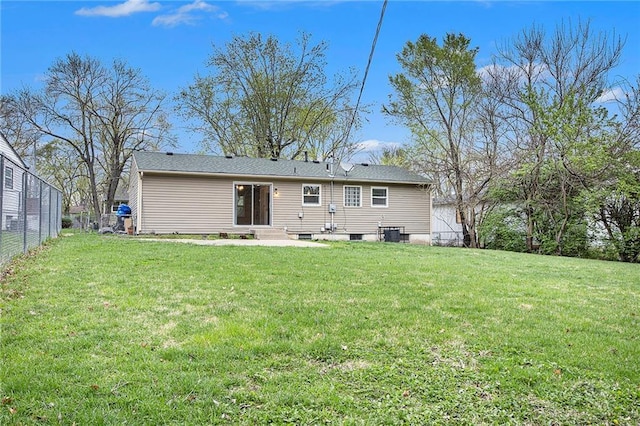 back of property with a lawn, entry steps, and fence