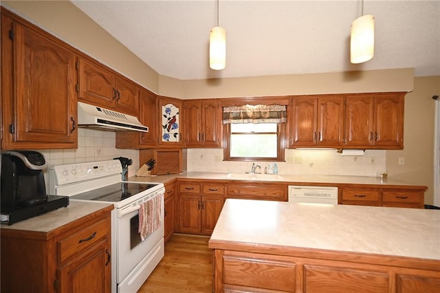 2406 NE 78th Ter, Kansas City, MO 64118 - kitchen with white appliances, extractor fan, and brown cabinetry