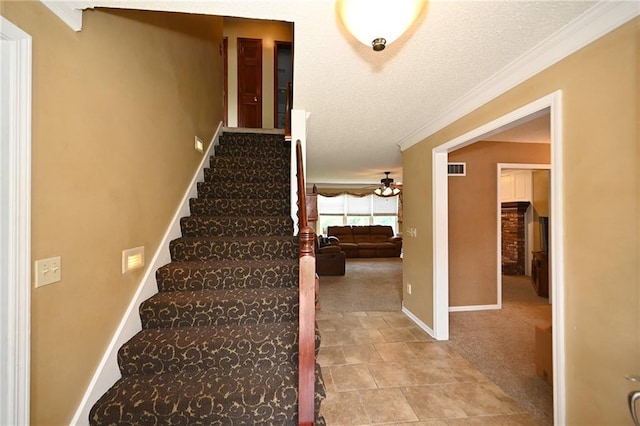 2406 NE 78th Ter, Kansas City, MO 64118 - staircase featuring ceiling fan, baseboards, crown molding, carpet floors, and a textured ceiling
