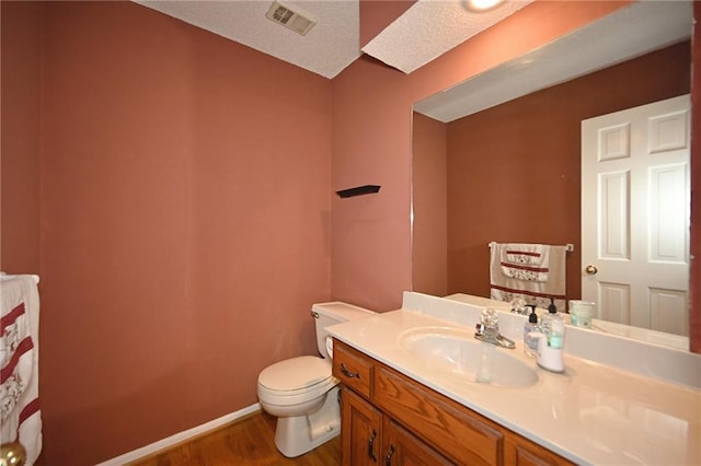 2406 NE 78th Ter, Kansas City, MO 64118 - half bathroom with wood finished floors, toilet, vanity, and baseboards