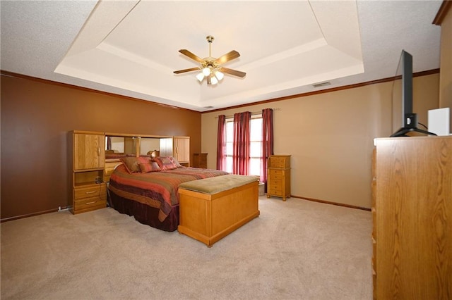 2406 NE 78th Ter, Kansas City, MO 64118 - bedroom with a tray ceiling, light colored carpet, baseboards, and a ceiling fan