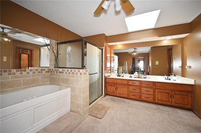 2406 NE 78th Ter, Kansas City, MO 64118 - full bathroom featuring ceiling fan, a skylight, a bath, and a shower stall