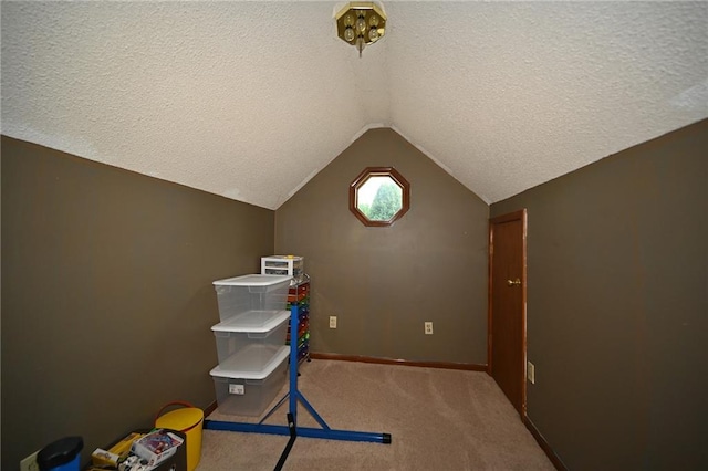 2406 NE 78th Ter, Kansas City, MO 64118 - playroom with vaulted ceiling, a textured ceiling, carpet flooring, and baseboards