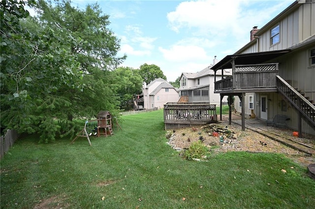 2406 NE 78th Ter, Kansas City, MO 64118 - view of yard with a deck, a patio area, stairs, and a playground