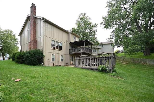 2406 NE 78th Ter, Kansas City, MO 64118 - back of house with a chimney, a deck, and a balcony