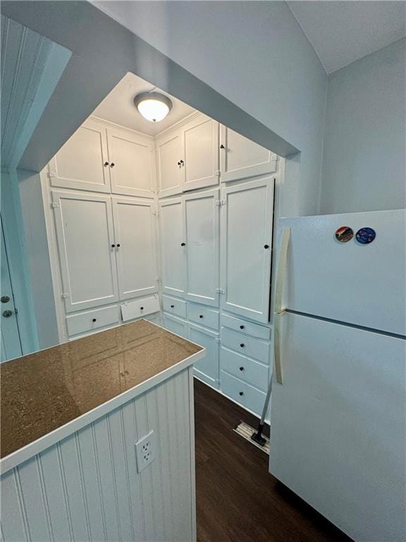 2518 N 12th St, Kansas City, KS 66104 - kitchen featuring dark wood finished floors, white cabinetry, and freestanding refrigerator