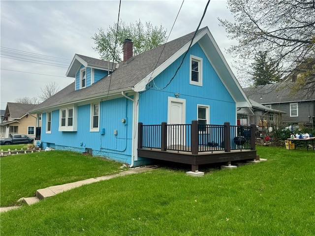 2518 N 12th St, Kansas City, KS 66104 - back of house featuring a lawn, a chimney, a deck, and roof with shingles